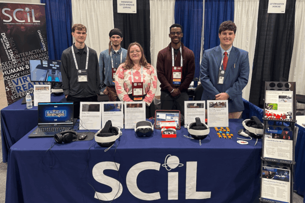 Students pose at a booth for the Shenandoah Center for Immersive Learning.