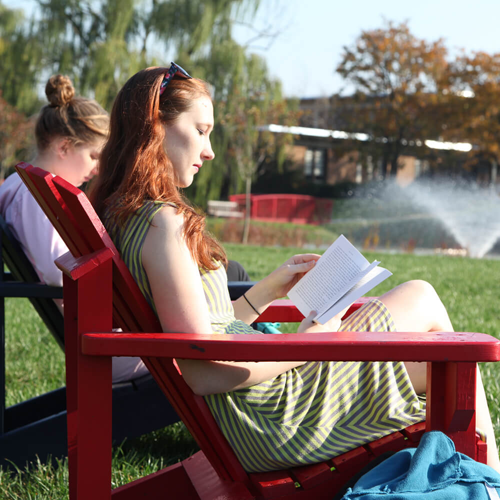 Student reading on campus