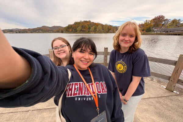 Shenandoah students take a selfie with a lake in the background.