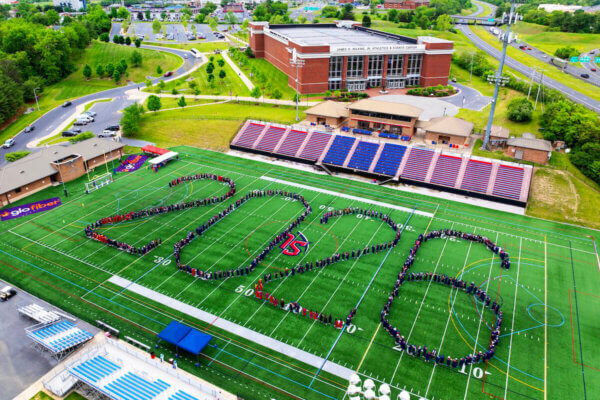 An aerial shot of the graduates spelling out 2026 on the football field.