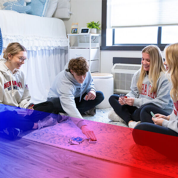 Students playing cards in University Inn dorm room