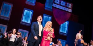 Man and woman holding a dog, with others behind, in Shenandoah Conservatory's 2024 production of "Legally Blonde."