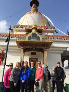 Group poses in front of Buddhist temple