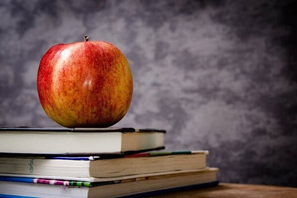 Photo of apple on top of books