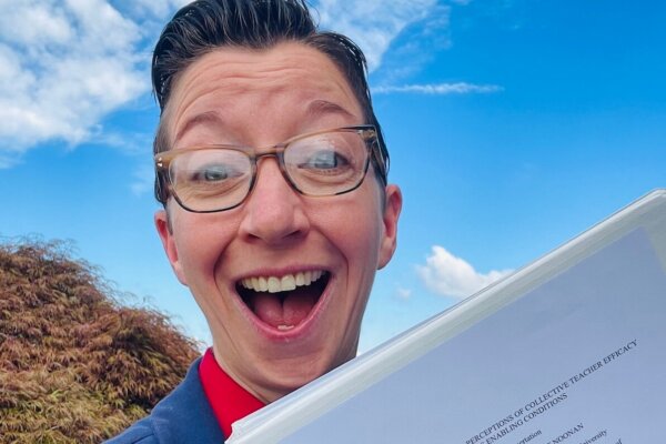 Shenandoah University Ph.D. in educational leadership student Annmarie Noonan '24, holding her award-winning dissertation.