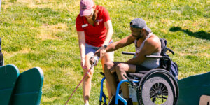 A Shenandoah University physical therapy student works with an adaptive athlete during the First Swing Seminar and Learn to Golf Clinic