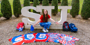 Victoria Hannen with the orientation T-shirts she's collected since 2019.