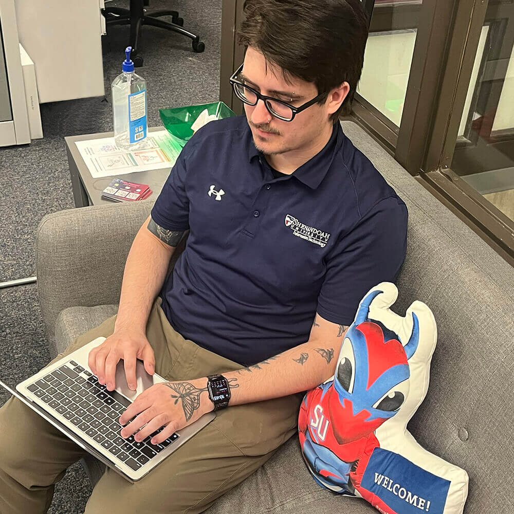 Help Desk staff member using a 13-inch MacBook Air M5