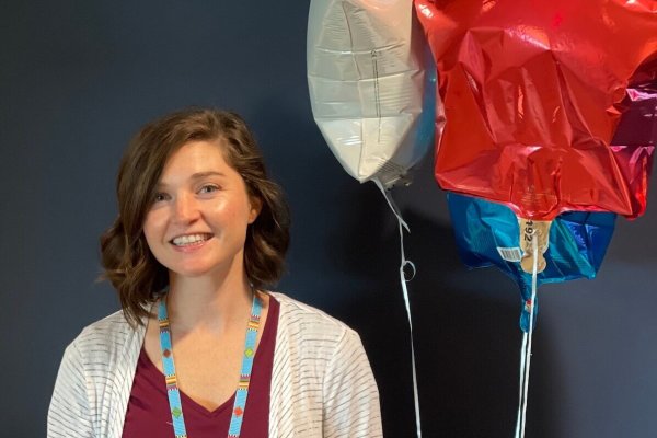 Assistant Professor of Occupational Therapy Morghen Sikes, Ph.D., MS OTR/L with balloons.