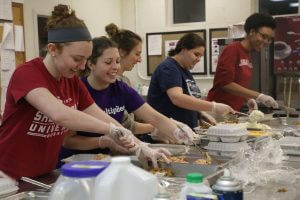 Image of students packing food for Campus Kitchens