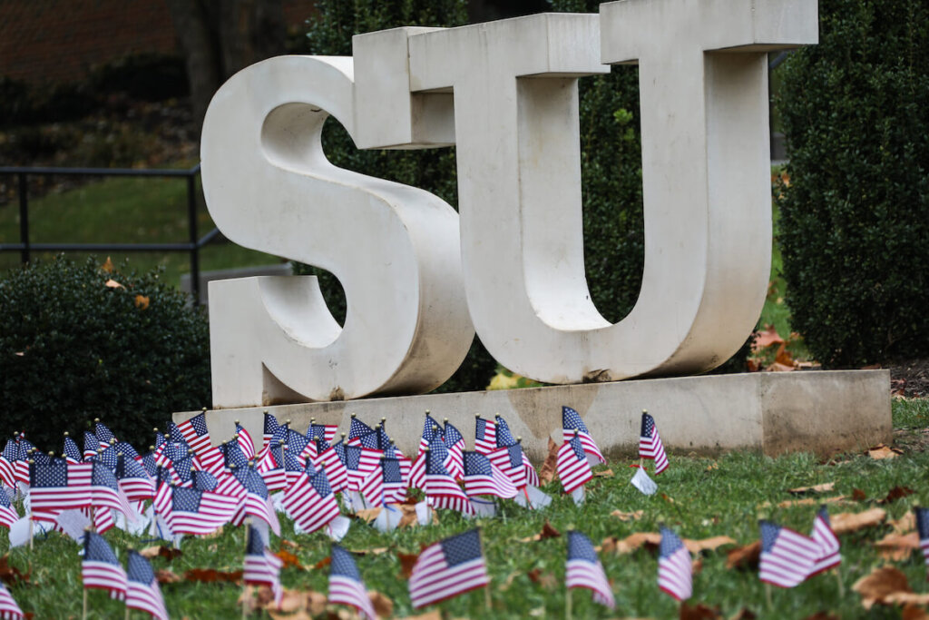 SU statue in Shenandoah University main campus Quad, surrounded by small U.S. flags. Photo by Caleb Rouse.