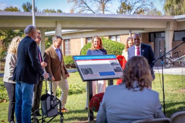 Members of the Wilkins family stand next to a historical marker recently installed on Shenandoah University's main campus.