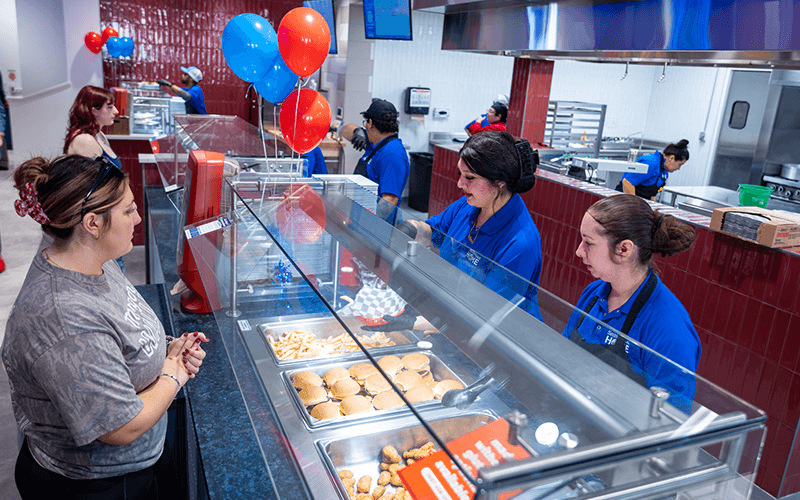 Students being served food at Allen Dining Hall