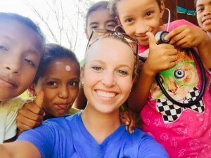 Physician Assistant Studies student Jillian Goles surrounded by children in Nicaragua