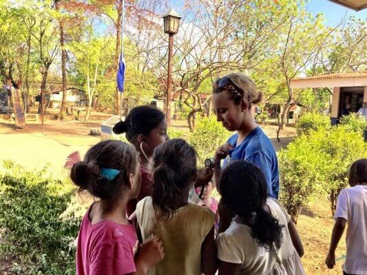 Physician Assistant Studies student Jillian Goles interacts with local children during a trip to Nicaragua