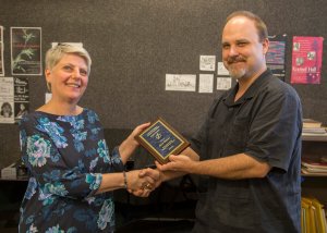 Doris Lederer (left) is presented with an award by Donovan Stokes (right)
