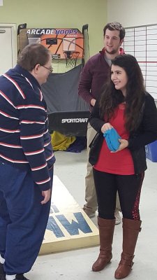 Senior business administration major and political science minor Casey Edsall ’16 (center) and junior business administration major Alexa Lazaro-Lopez ’17 play cornhole with one of their Buzzy Buddies during the kickoff event.
