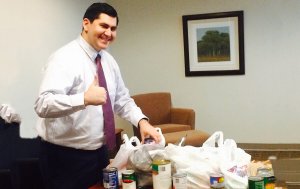 Thomas Caracciolo, first year MBA graduate student, graduate advisor and Sport Business Club member with a few of the collected items