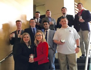 Shenandoah University's Debate Team wins at Ball State in 2017. Photo shows team members with their canning jar trophies.
