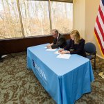 President and COO of Inova Mark Stauder (left) and Shenandoah University Vice President for Academic Affairs Adrienne Bloss, Ph.D., (right) sign an agreement marking the expanded, collaborative partnership.