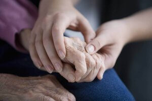 Closeup photo of two people holding hands