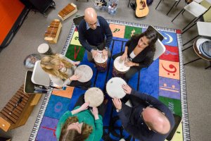 Shenandoah University graduate music therapy photo. Students & faculty playing drums. Accompanies late 2017 news items about music therapy program, students, faculty and alumni.