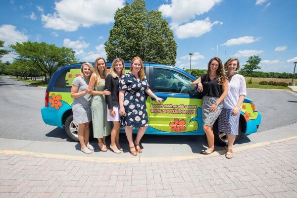 PA students who raised funds for Special Love, Inc. with Special Love's signature Mystery Machine-style van.  