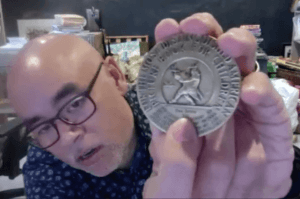 Dan Santat shows his Caldecott Medal during his 2021 Shenandoah University Children's Literature Conference presentation