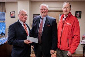Shenandoah Senior Vice President and Vice President of Advancement Mitch Moore, Loren Swartzendruber of Secure Futures and Shenandoah Director of Physical Plant Barry Schnoor with Renewable Energy Credits Check