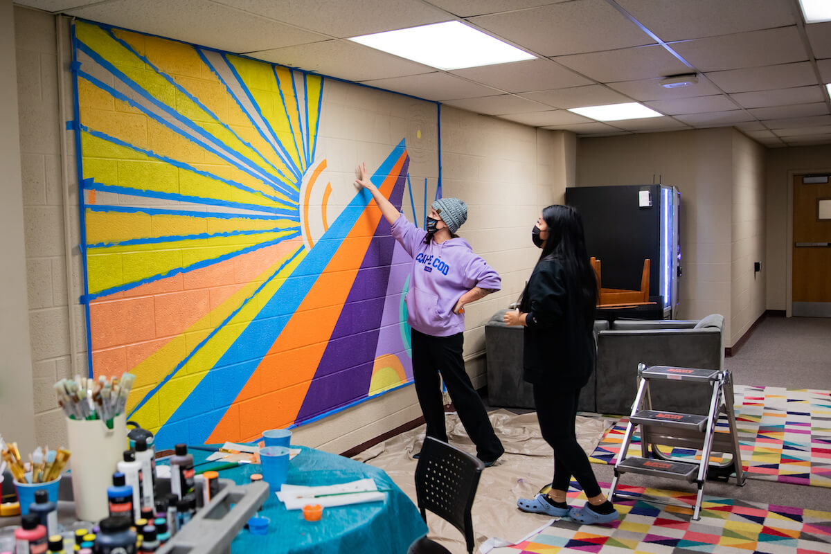 Making A Creative Buzz Mural painting course students brighten the walls of Gregory Hall during J Term