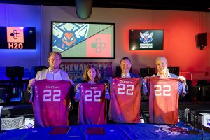 H20 CEO Martijn van der Craats, Shenandoah University President Tracy Fitzsimmons, Provost Cameron McCoy and Dean of the School of Business Astrid Sheil display their custom SU esports jerseys