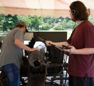 Shenandoah University's virtual reality design professor Nathan Prestopnik and student Luke Yager record audio of a French 75 artillery gun
