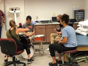 Shenandoah University music therapy and physical therapy students work with a pediatric patient