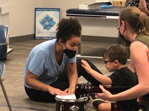 Shenandoah University music therapy and physical therapy students work with a pediatric patient