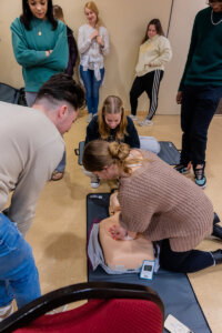High school students practice CPR