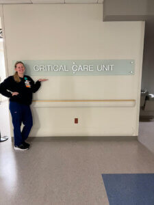 Shenandoah University nursing student Alyse Bragg poses with a sign for Winchester Medical Center's Critical Care Unit