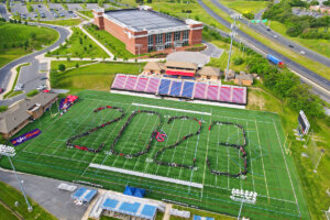 Shenandoah University graduates form the year "2023" at Shentel Stadium