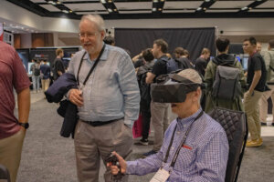 Shenandoah University Professor of History Warren Hofstra operates a VR program as JMU professor Kevin Hardwick observes during the Augmented World Expo