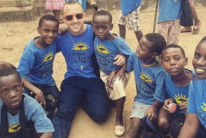 Christopher Ciccarelli ’17 with kids he helped on an overseas trip.