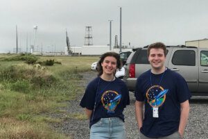 Shenandoah students Shannon Eissele and Connor Hill at Wallops Island with the sounding rocket launch site in the background