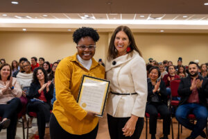 Shenandoah University alum Ashayla Byrd poses for a photo with President Tracy Fitzsimmons.