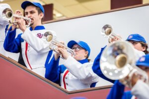 Members of Shenandoah University's Marching Band perform on the stairs inside Smith Library.