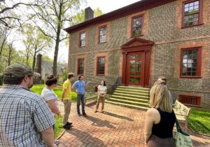 A group of people stands in front of the Wilton House Museum in Richmond, Virginia