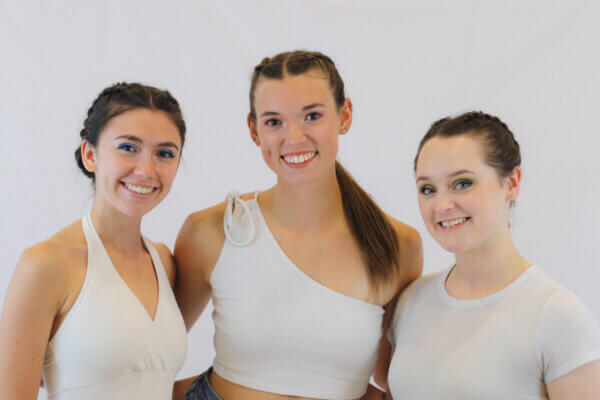 Eve Stanley, Lainey Griffin and Becca Hopkins of Arte in Movimento dance company. All three are Shenandoah University graduates and dressed in white. 