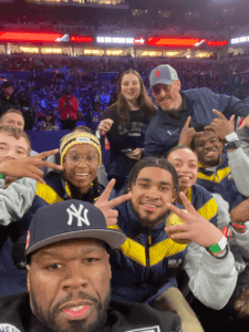 Shenandoah University students pose for a selfie with rapper 50 Cent during NBA All-Star weekend festivities in Indianapolis.