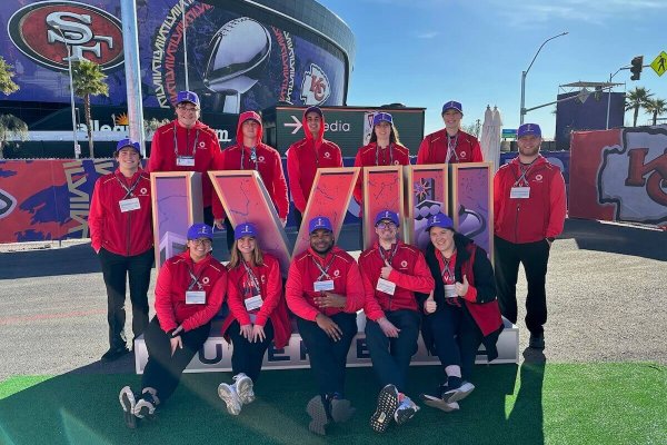 Shenandoah University students pose with the Super Bowl LVIII logo in front of Allegiant Stadium in Las Vegas.