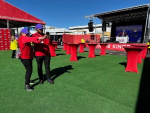 Two Shenandoah University students take photographs in the space that hosted the Kansas City Chiefs pregame party before Super Bowl LVIII.