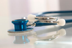 Stock image of a stethoscope on a table.