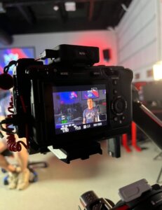 A camera records an interview with an Shenandoah University esports student during the filming of a documentary.
