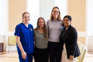 Carrie Conway of the Lettie Pate Whitehead Foundation poses for a photograph with three Shenandoah University nursing students.